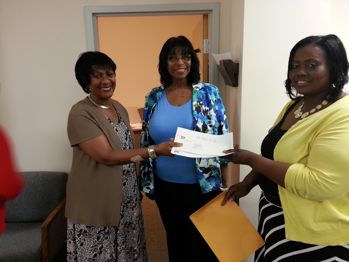 Diane Paige’Blondet, Executive Director/CEO of MSP (on left), and Patricia Camp, MSP Grants Writer (center), accept a donation to My Sisters’ Place from a representative from the TJX Foundation.