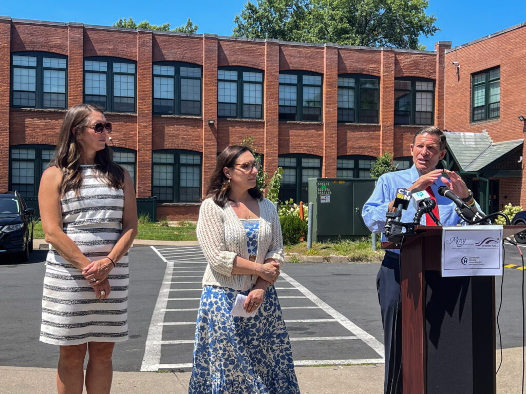 Amy Pelletier, CEO Kara Capone, and Senator Richard Blumenthal outside of the Beaumont Lofts.